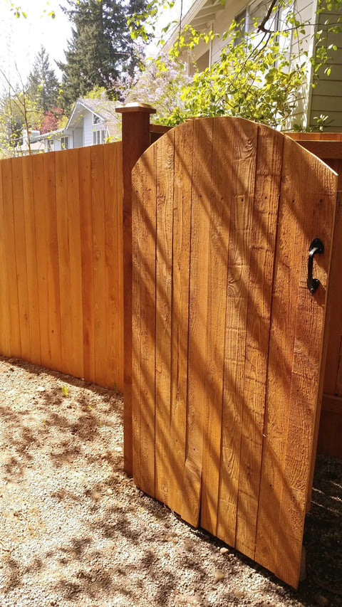 Built Different Exterior Wood Stain And Heavy Duty Fence Guard With Seriously Tough Water Repellent Finish Sierra Cedar Tint used on a wooden gate.