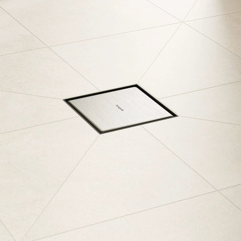 Square Tileable Shower Drain Set With Brushed Stainless Steel Construction And Flush Floor Mount Design For Modern Bathrooms installed in a light tiled floor.
