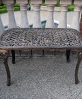 Mississippi Cast Aluminum Outdoor Cocktail Table 35 Inch Long By 18 Inch Wide In Antique Bronze on patio near pool