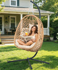 Cozy Hanging Egg Chair With Stand And Plush Cushions for indoor outdoor chill sessions on patio with natural wood finish.