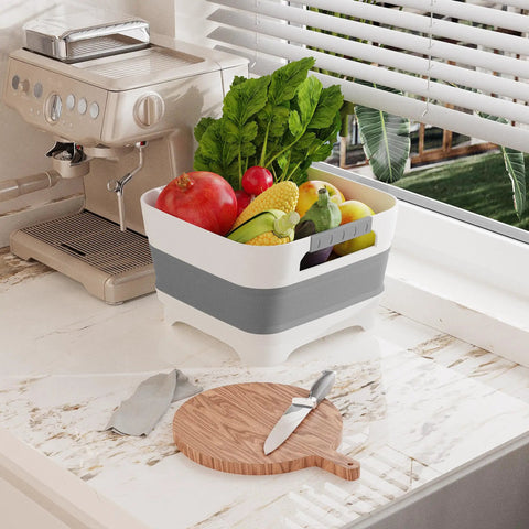 Collapsible Wash Basin With Drain Plug 2.4 Gallons For Kitchen And Camping on countertop full of fresh vegetables