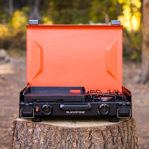 2364 12 By 14 Camping Griddle With Side Burner Nonstick Ceramic Titanium Coated Surface on a tree stump in forest setting