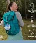 Woman with backpack carrying On The Go Travel Case For Collapsible Bottles Bowls And Cups With Carabiner Clip Protective Storage