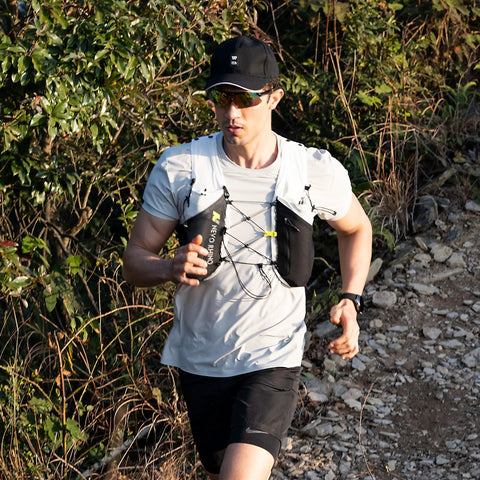 Runner wearing 5L Hydration Running Vest With Dual 500ml Soft Flasks, Lightweight Nylon Pack, Adjustable Chest Straps on a trail