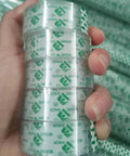 Hand holding Value Pack 48 Clear Tape Rolls for Dispenser 3/4 x 1000 Inches Each 1 Inch Core Go-To Gift Wrapping Tape