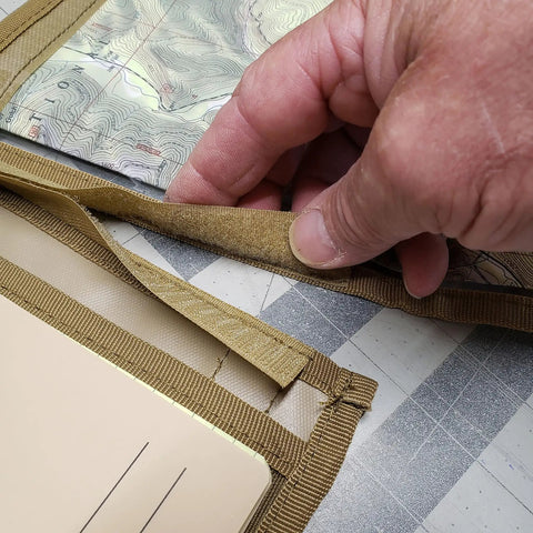 Advanced Compass Navigation Kit With Multifunction Case And Protective Map Pouch in tan being opened by hand