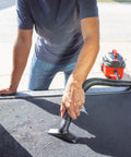 Pro-Grade 1-1/4 In Wet Dry Shop Vac Attachment Kit With Reinforced 11 Ft Hose. Man vacuuming car upholstery with attachment.
