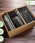 Fully Compostable 380 Piece Cutlery Set With 7 Inch Forks Spoons And Knives In Black Tray Eco Friendly Durable Heat Resistant Plastic Alternative For Parties And Events Great For Camping Picnic Catering And Office Lunches. open tray with black compostable forks, spoons, and knives