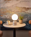 10 Inch Table Lamp With Marble Base And Frosted Glass Shade, Cozy Bedside Reading Light on a round table in a living room