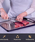 Front view of Matiks stainless steel cutting board, 16×11 inches, double-sided metal board with black border and built-in handle