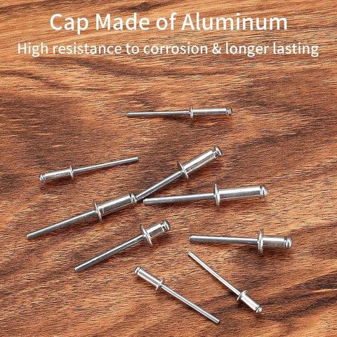 500 Piece Aluminum Blind Rivet Kit With 14 Size Assortment Pop Rivets Set scattered on wooden surface, high corrosion resistance.