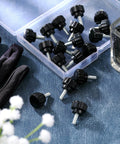 Knurled Threaded Thumbscrews M4 X 10mm For Monitor Mounts Carbon Steel Black 10 Pack, laid out on surface, box partially visible