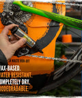 Person applying BananaSlip Tungsten All Weather Lube For Road Mountain Race And EBike Use Wax Based Water Resistant Dry Formula Biodegradable Lubricant In 50ml Bottle to a bike chain