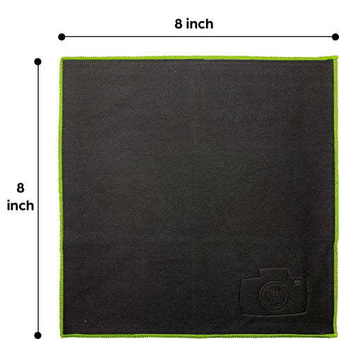 Front view of an 8x8-inch black microfiber cleaning cloth with lime-green edge and small logo patch.