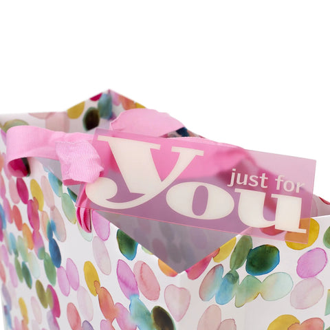 Close-up of 10.47 Inch Square Gift Bag With Watercolor Dots And Just For You Design, pink ribbon handle visible