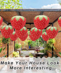 Strawberry Paper Lanterns Set Of 4 Large 8 Inch And 12 Inch Hanging Decor 3D Red Strawberry Party Lanterns displayed in garden.