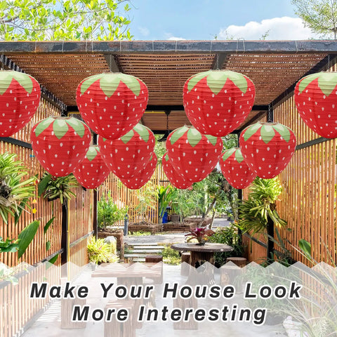 Strawberry Paper Lanterns Set Of 4 Large 8 Inch And 12 Inch Hanging Decor 3D Red Strawberry Party Lanterns displayed in garden.