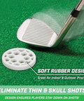 Golf club striking a white rubber training disc on green turf, design for eliminating thin and skull shots, suitable for indoor and outdoor practice.