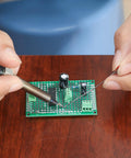 Hands soldering on a 40 Pack Prototyping Printed Circuit Boards Kit With Five Size Universal Perforated Solderable Proto Boards For DIY Electronics Projects Plated Through Holes For Easy Soldering