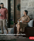 Couple enjoying coffee on Solana 70 Gallon Storage Bench Deck Box for Patio Furniture and Outdoor Seating with All Weather Resin