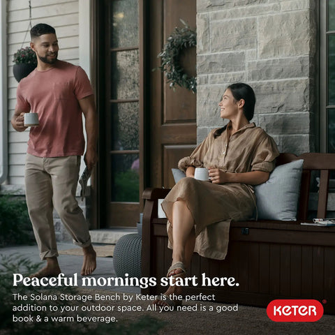 Couple enjoying coffee on Solana 70 Gallon Storage Bench Deck Box for Patio Furniture and Outdoor Seating with All Weather Resin