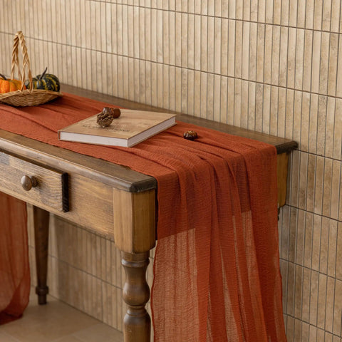 Rustic Fall Thanksgiving Table Runner Terracotta Cheesecloth Weave 120 Inches Long Hand Dyed Soft Cotton Gauze on wooden table.