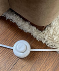 Nine Foot Three Outlet Extension Cord With Foot Switch Lets You Tap Lamps Appliances And Lighting On Or Off Perfect For Senior Living 125VAC White Pack Of Two, shown on wooden floor near carpet.