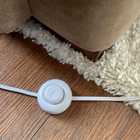 Nine Foot Three Outlet Extension Cord With Foot Switch Lets You Tap Lamps Appliances And Lighting On Or Off Perfect For Senior Living 125VAC White Pack Of Two, shown on wooden floor near carpet.