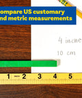 Folding Meter Stick With Inches, Centimeters, Millimeters And Meters For Quick Imperial And Metric Measurements on wood table