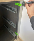 Hand using Built Like A Boss 3 Piece Scribe Jig Set on cabinetry for precise marking on toe kicks and fillers.