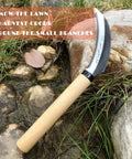 Grass Sickle With Sawtooth Edge Weeding Hoe For Garden on rocks, focus on stainless steel blade and wooden handle