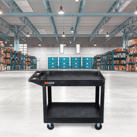 Extra Large Two Shelf Utility Cart With Heavy Duty Wheels 500 Pounds Capacity Rolling Tool Cart For Warehouses Industrial Settings Auto Garages And More Black 45.5 X 24.5 Inches in a warehouse setting.