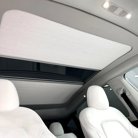 Fully Retractable Aluminum Sunroof Sunshade For Tesla Model Y shown inside cabin, blocking sunlight on panoramic roof.