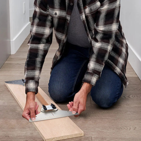 Person using Stair Tread Template Tool For DIYers And Beginners, Stair Gauge Set with Carpenter Pencil and Level on wooden plank