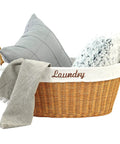Rattan Laundry Basket With Easy Carry Handles And Removable White Cotton Liner filled with pillows and throw, natural wicker hamper