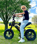 Teen riding Raw Power 1000W Fat Tire Electric Bike for Teens and Kids 48V 15.6Ah in park setting, showcasing bike design