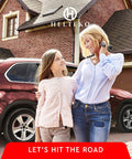 Mother and daughter smiling beside a red SUV parked in a residential driveway.