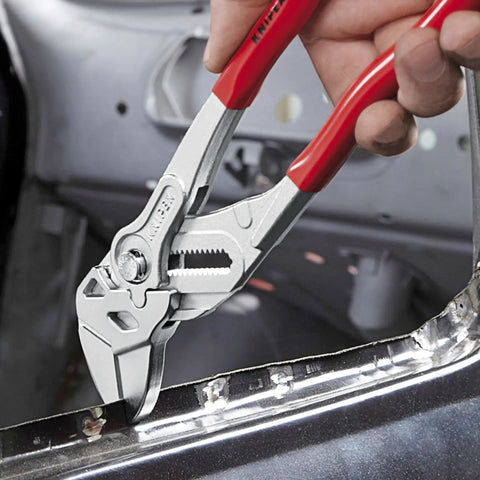 Hand using Three Piece Pliers Wrench Set With 7 10 12 Inch Sizes For Quick Grip And Tough Tightening DIY Auto Plumbing Kit