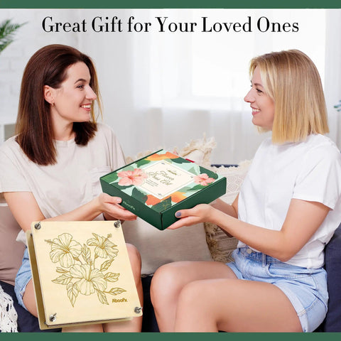 Two women exchanging a 11x11 Inch 10 Layer Flower Press Kit for DIY crafts pressed flowers, featuring a floral design on the package.