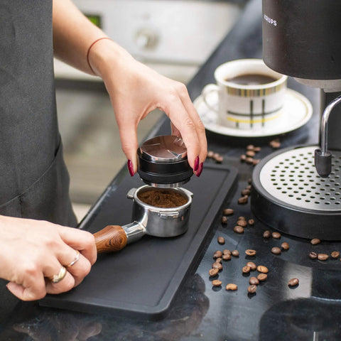 Using Ultra Thick Espresso Tamping Mat For Large 5x12 Inch Coffee Bar Station Silicone Tamper Pad with portafilter on countertop
