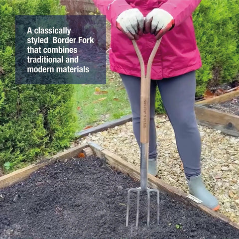 Traditional Stainless Steel Border Fork For Aerating Weeding And Digging With Comfortable Wooden Handle Heavy Duty Garden Tool For Backyards And Raised Beds Durable And Corrosion Resistant Workhorse being used in a garden bed.