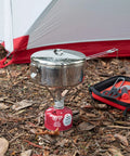 Beefy Stainless Steel Stowaway Camping Pot 475 mL With Locking Lid And Fold Over Handle at campsite on portable stove
