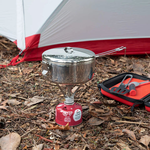 Beefy Stainless Steel Stowaway Camping Pot 475 mL With Locking Lid And Fold Over Handle at campsite on portable stove