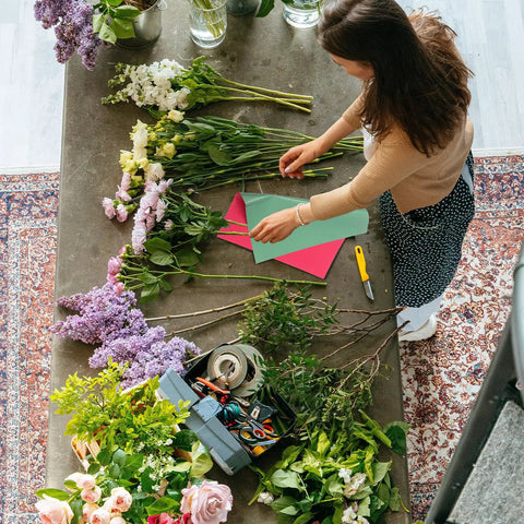 Person arranging flowers with Double Sided Floral Bouquet Wrapping Paper For Gift Packaging Totally Nice Flower Wrap Sheets
