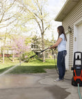 Person using Beastly 2000 Max PSI Electric Powered Pressure Washer With 14.5 Amp Motor, 1.5 GPM to clean driveway.