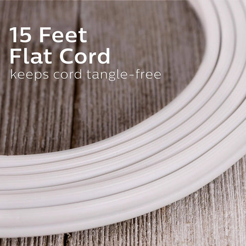 Close view of fifteen foot three outlet flat plug extension cord, white color, coiled on wooden surface