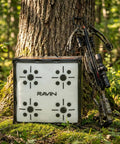 650 FPS Ravin Edition Crossbow Target For Archery Ultra High Speed Stop With Aramid Core Technology beside a tree with crossbow.