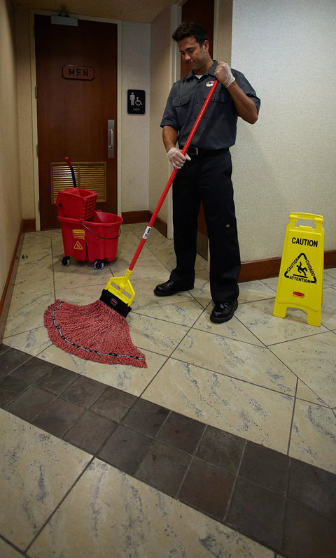 26 Inch Heavy Duty Yellow Caution Sign For Slip Hazards And Wet Floors Twin Sided High Visibility Standup Floor Sign in use by a worker.