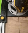 Slick Guide Rail Adapter For Trim Routers with steel connector showing precise cut on wood surface.