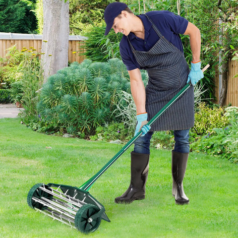 Person using Rolling Lawn Aerator 18 Inch With Fender And Tine Spikes, Anti Slip Handle, Manual Soil Aeration Tool on grass